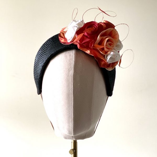 Olivia_ front view of black straw halo with vintage ribbon roses and coque feathers