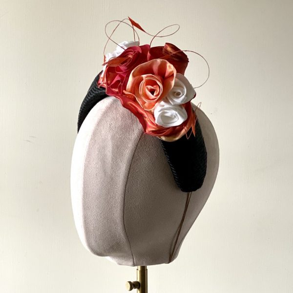 Olivia_ side view of black straw halo with vintage ribbon roses and coque feathers