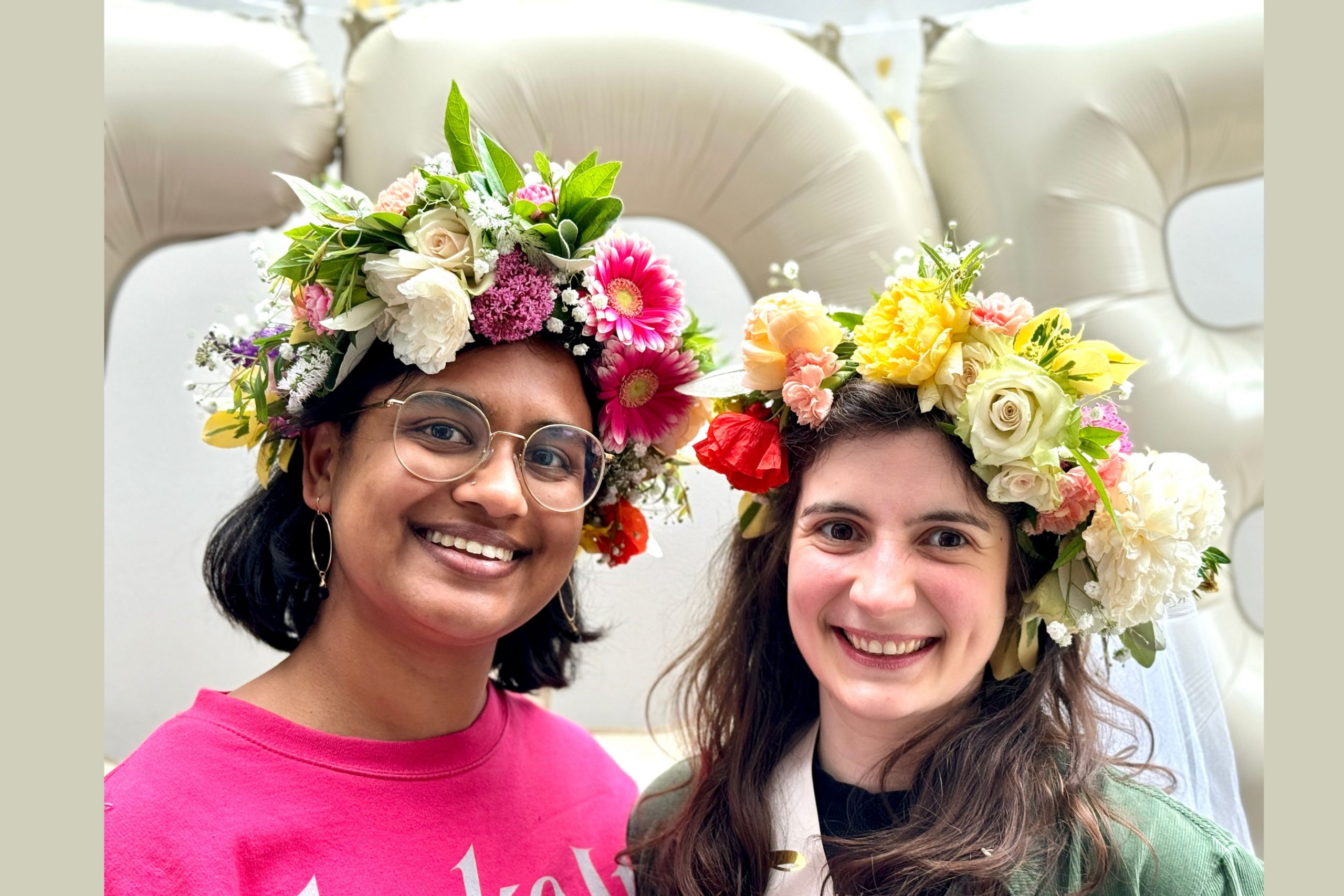 Delighted bride and bridesmaid wearing their finished flower crowns 