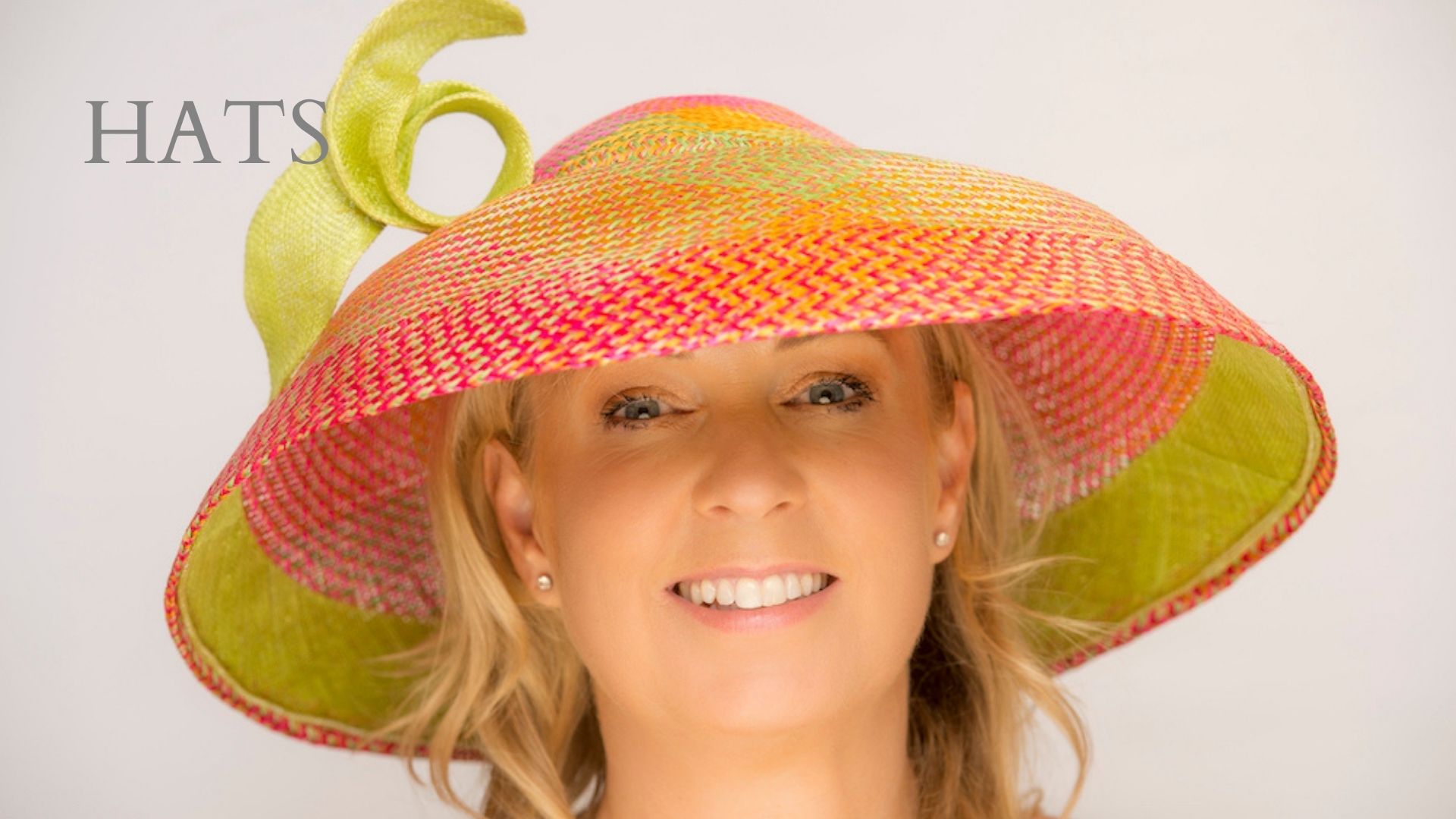 Dior style large brimmed hat and a wired brim made from green and orange buntal straw